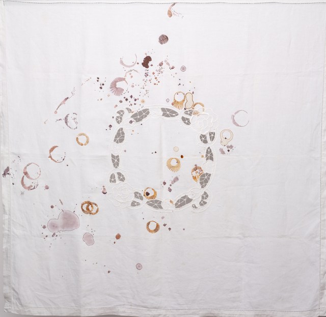 Tablecloth with stains of wine and tea stitched into with hand embroidery.