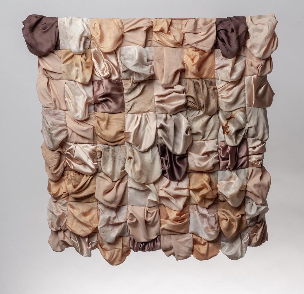 Textile quilt made from various flesh coloured silks, made to sag and drape