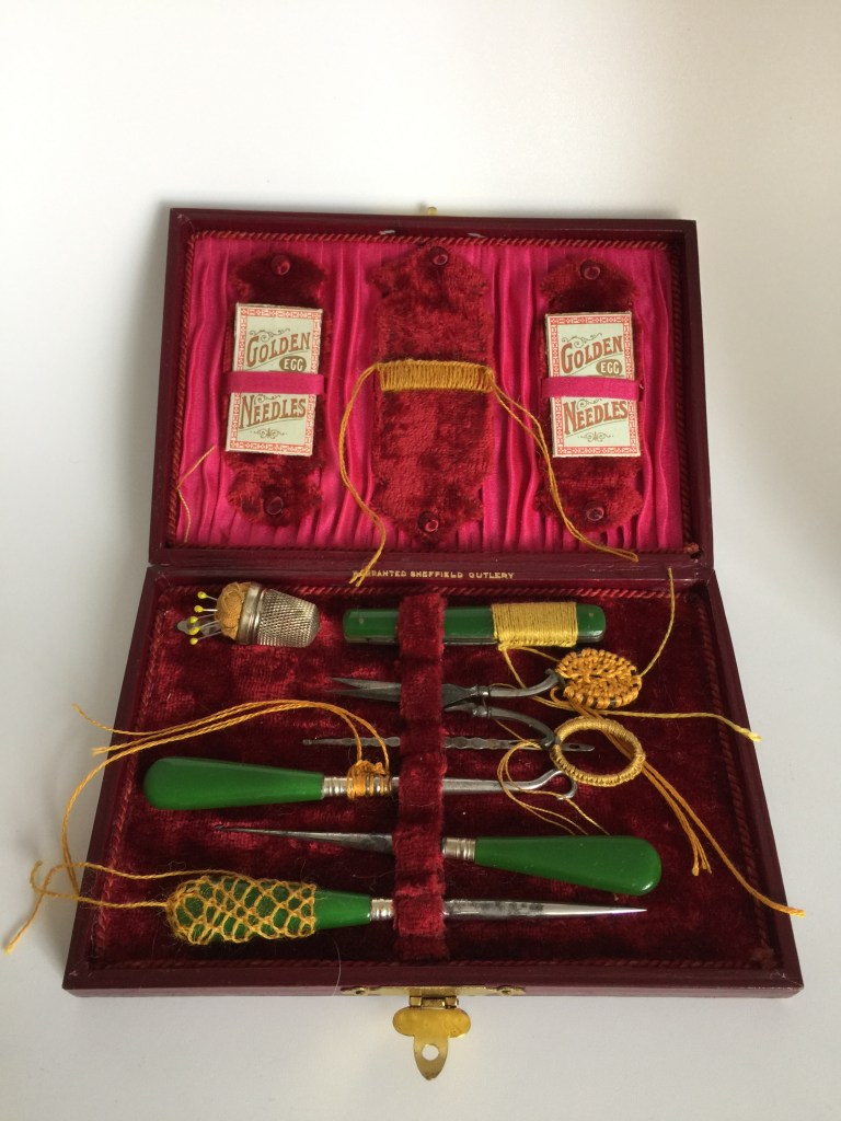 photo of red silk lined box of victorian sewing tools with stitching and embellishment by Ruth Singer.