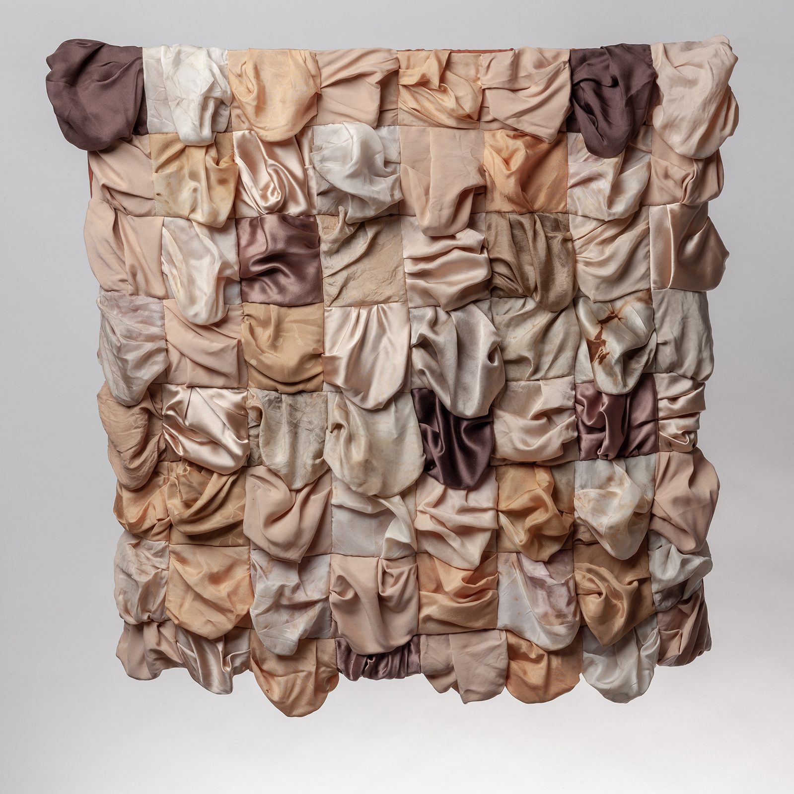 Textile quilt made from various flesh coloured silks, made to sag and drape
